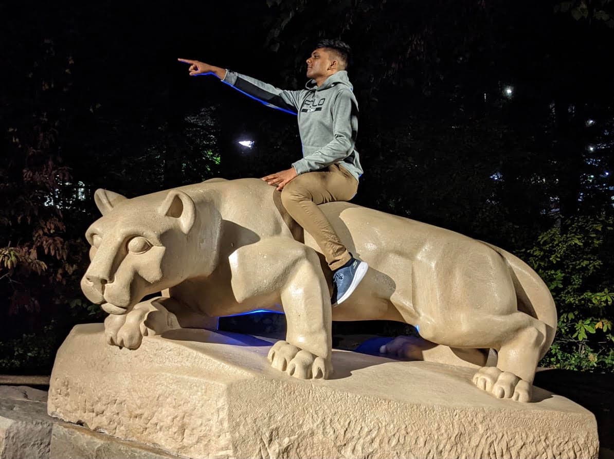 Ruthvik sitting on the Nittany Lion Shrine